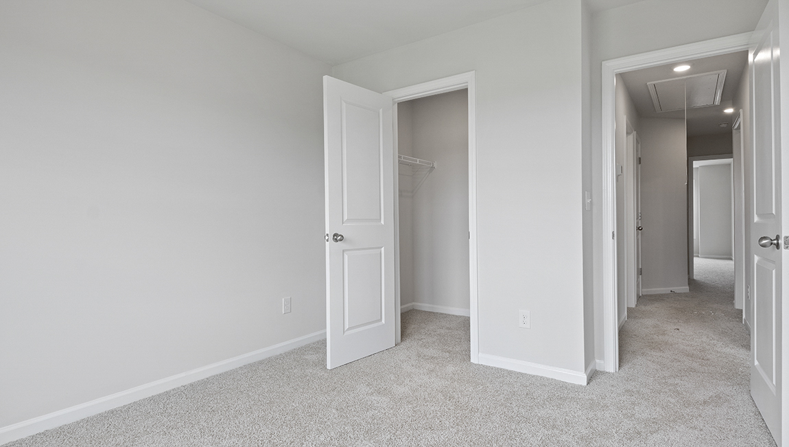 Bedroom with carpet and window.