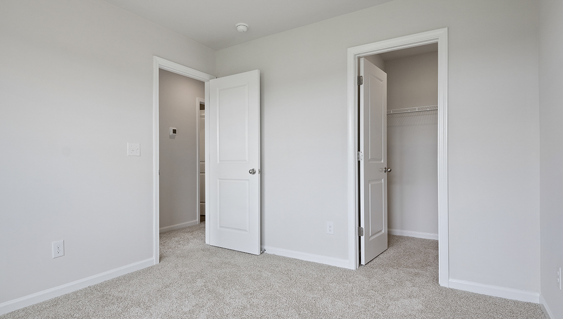Bedroom with carpet and window.