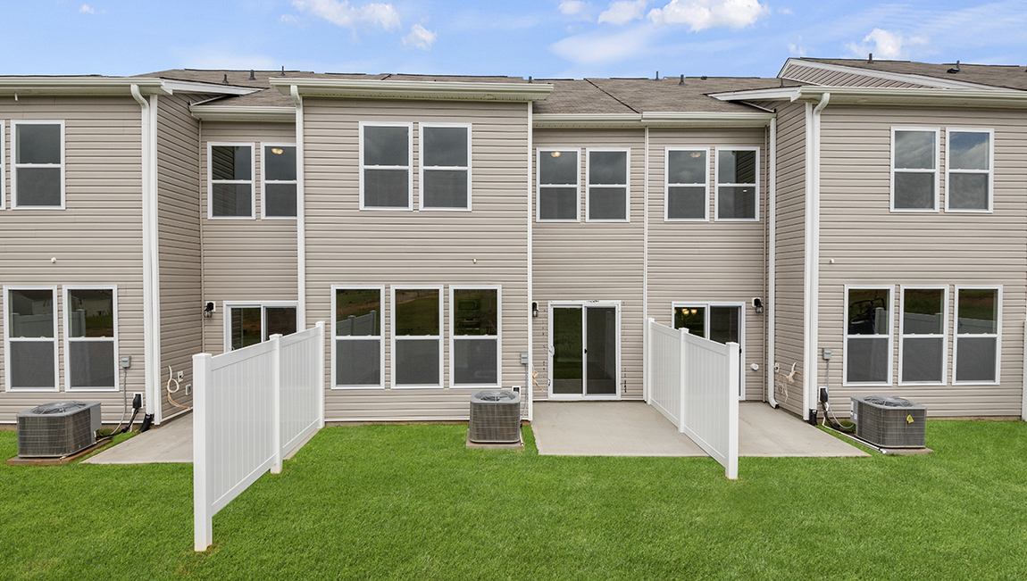 Exterior of twonhome with backyard.