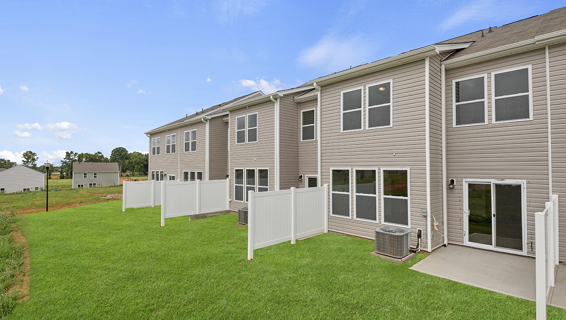 Exterior of twonhome with backyard.