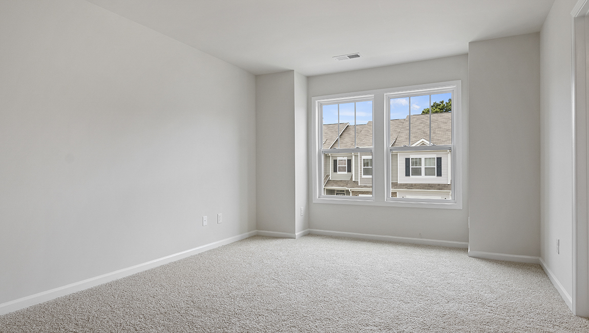 Bedroom with carpet and window.