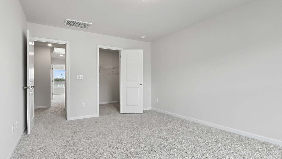 Bedroom with carpet and window.
