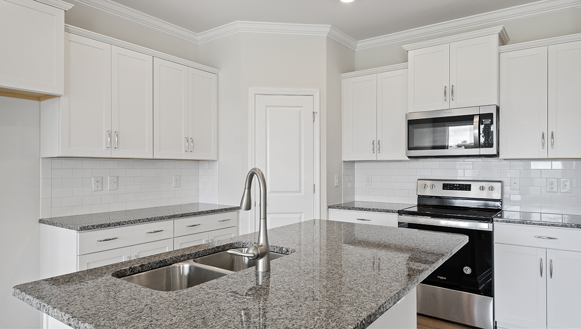 Kitchen and island with granite counter tops.