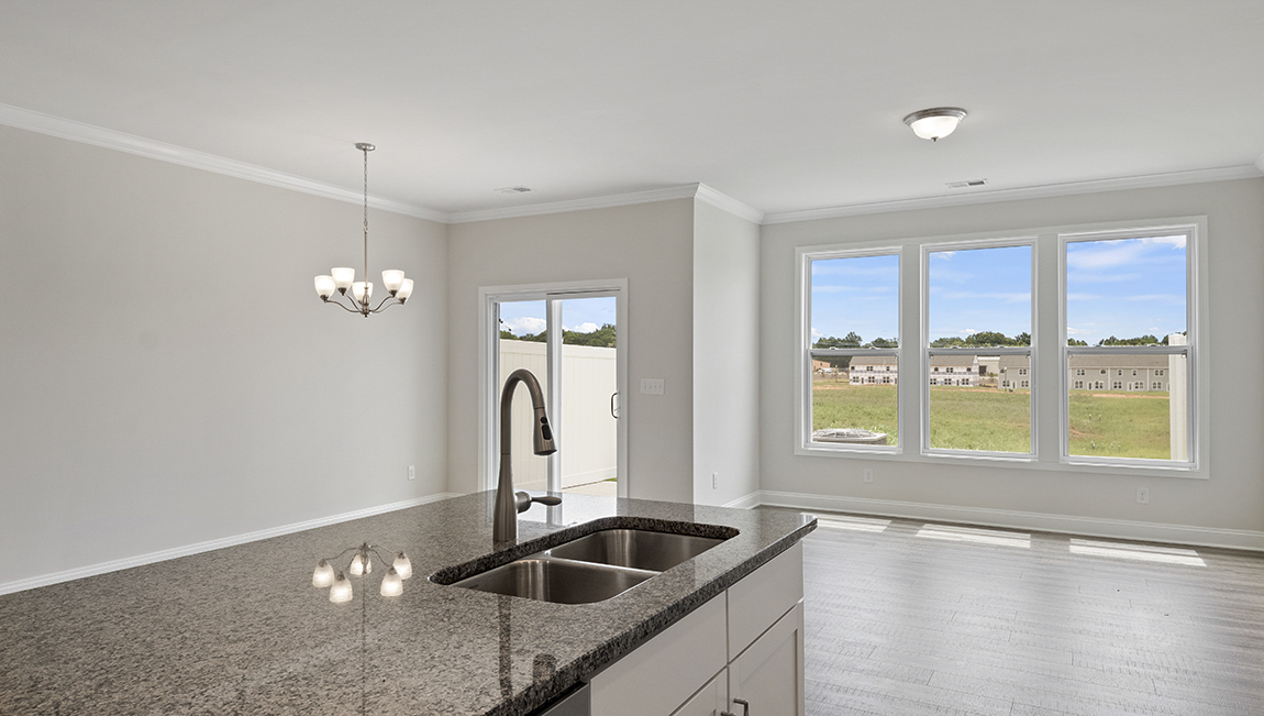 Kitchen and island with granite counter tops.