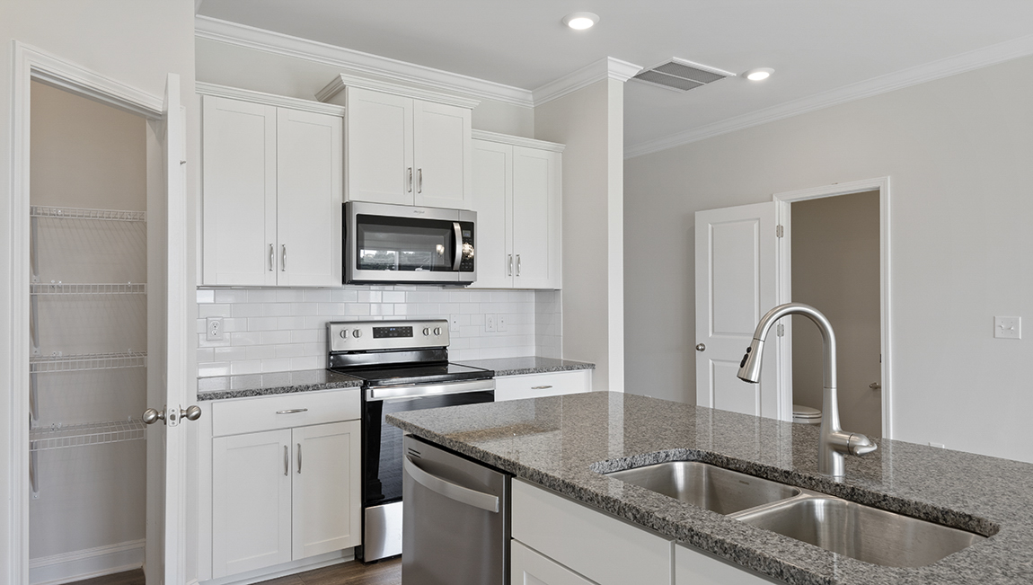 Kitchen and island with granite counter tops.