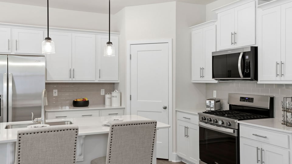 Kitchen with quartz countertops and stainless steel appliances.