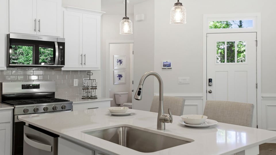 Kitchen with quartz countertops and stainless steel appliances.