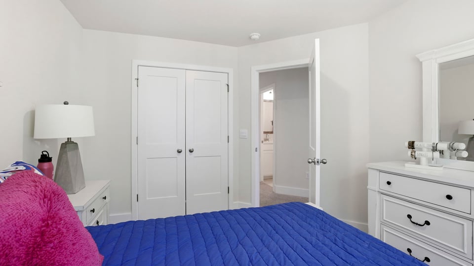 Bedroom with carpet and window.