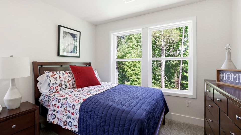 Bedroom with carpet and window.