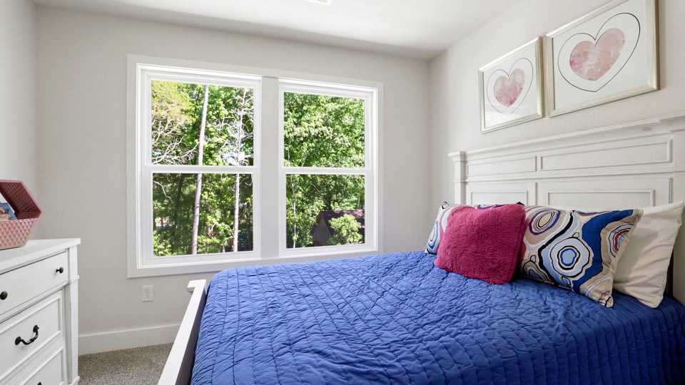 Bedroom with carpet and window.