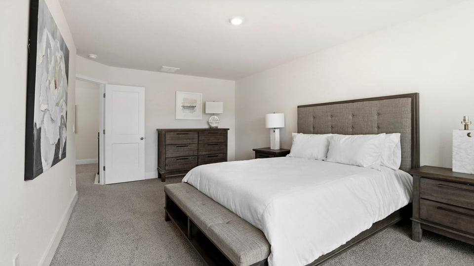 Bedroom with carpet and window.