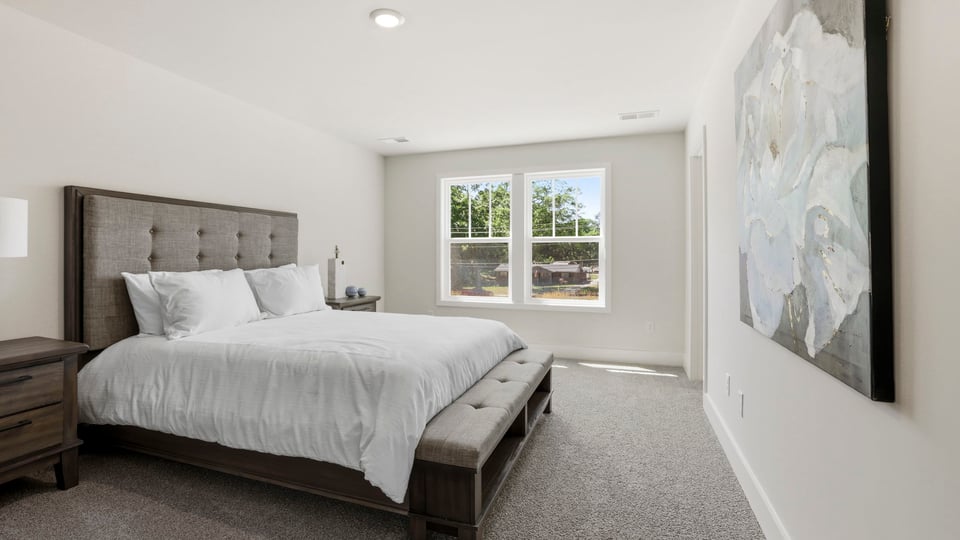Bedroom with carpet and window.