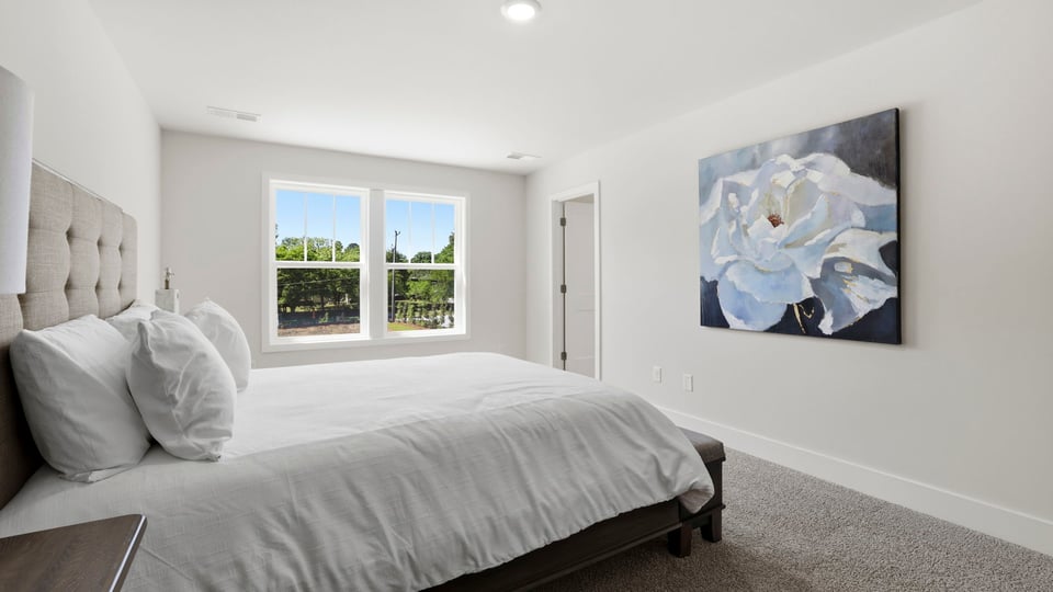 Bedroom with carpet and window.