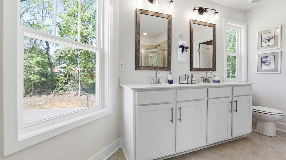 Bathroom with double vanity sink and window.