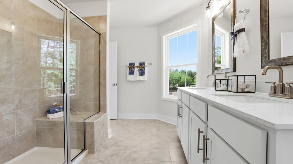 Bathroom with double vanity sink and walk in shower.