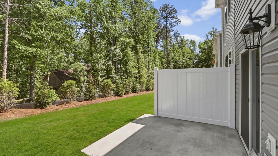 Back exterior of home with patio.