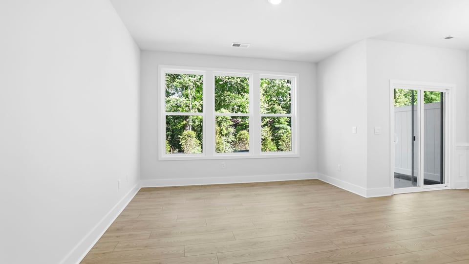 Kitchen and island with quartz countertops and stainless steel appliances.