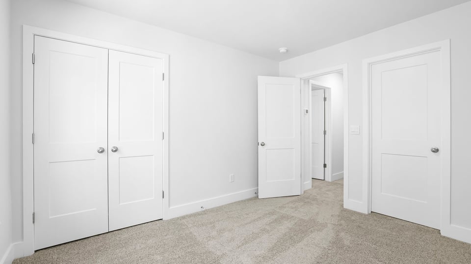 Bedroom with carpet and window.