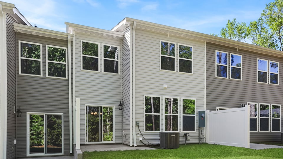 Back exterior of home with large backyard.