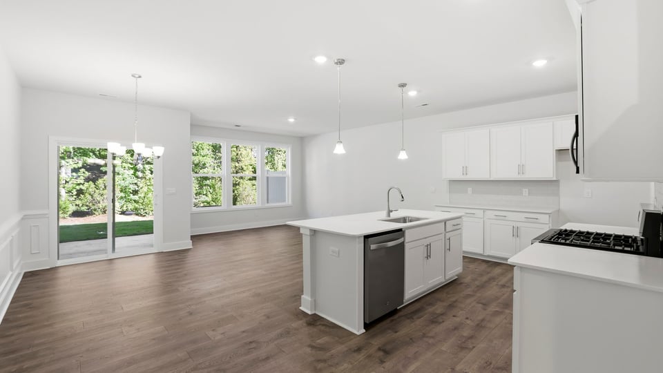 Kitchen and island with quartz countertops and stainless steel appliances.