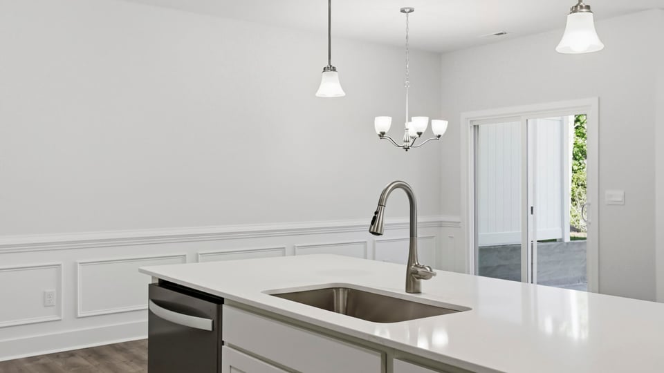Kitchen and island with quartz countertops and stainless steel appliances.
