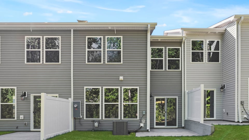 Back exterior of home with large backyard.