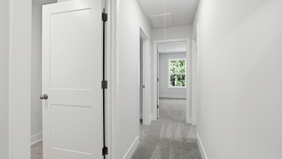 Hallway upstairs with carpet.