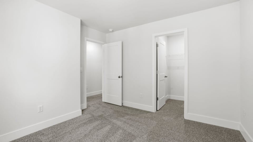 Bedroom with carpet and window.