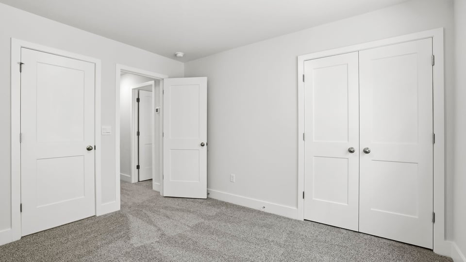 Bedroom with carpet and window.