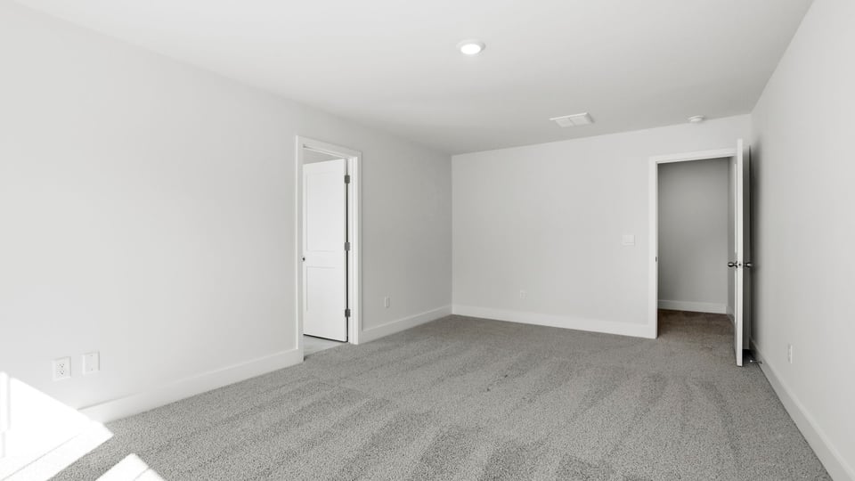 Bedroom with carpet and window.