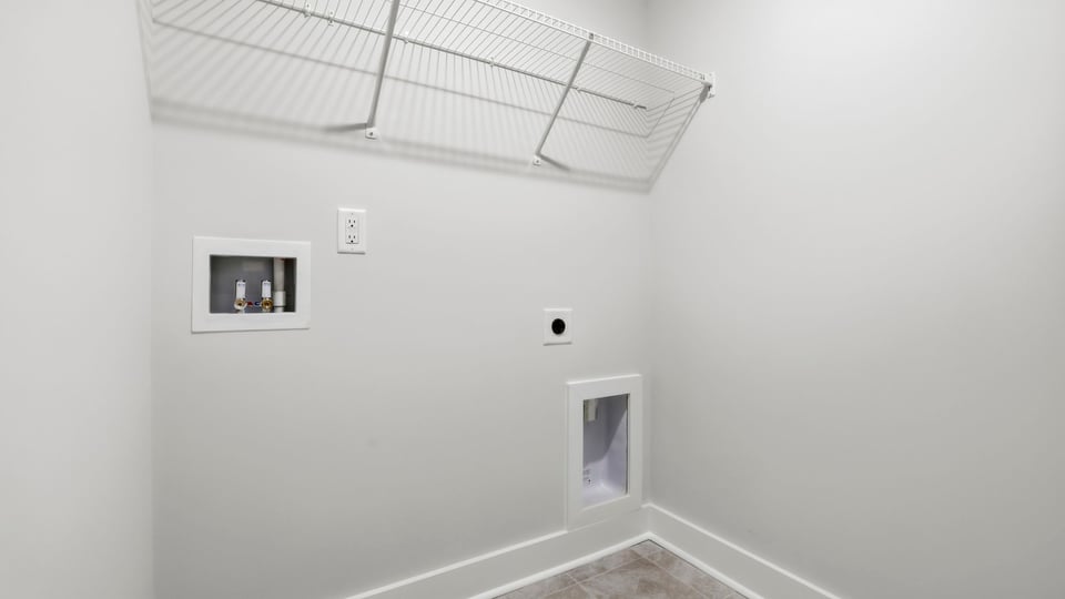 Laundry room with hanging storage racks.