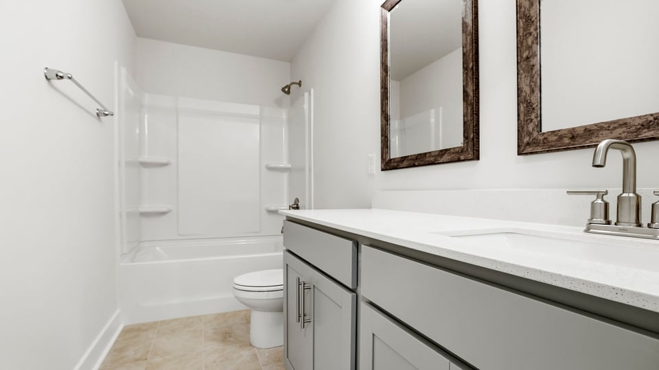 Bathroom with double vanity sink and tub.