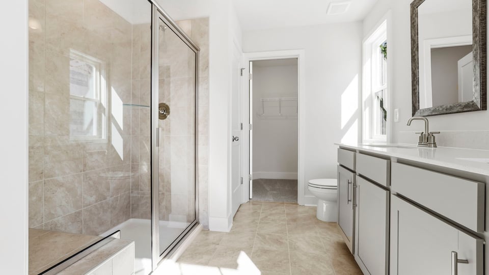 Bathroom with double vanity sink and shower.