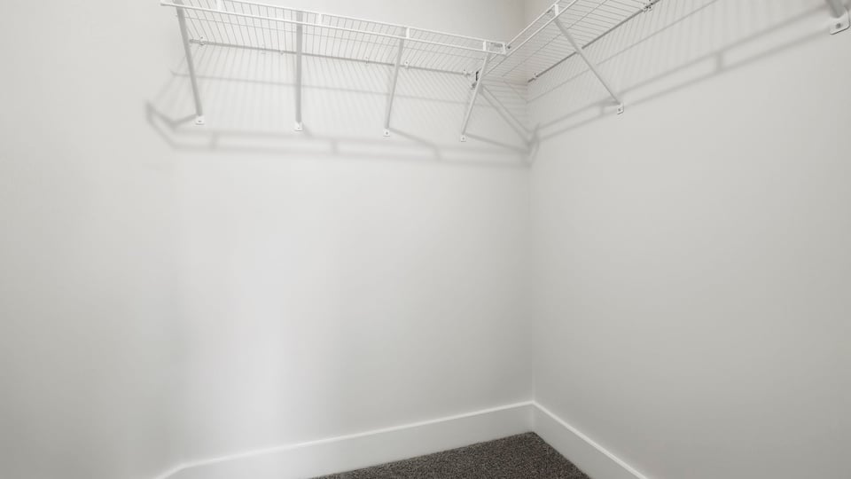 Closet with hanging storage racks.