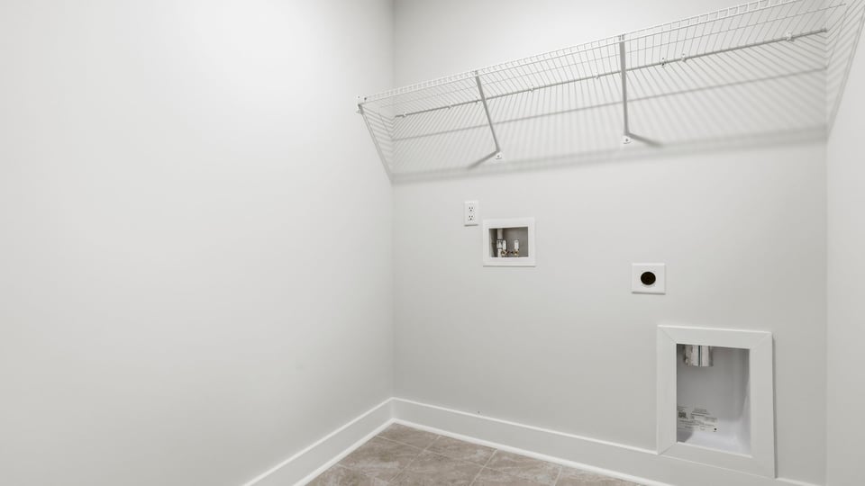 Laundry room with hanging storage racks.