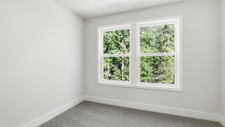Bedroom with carpet and window.