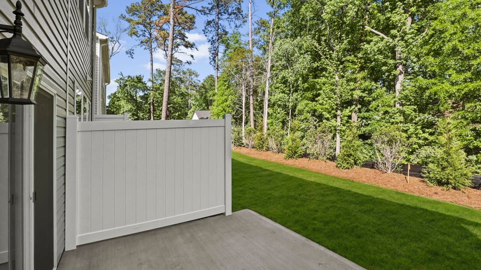 Back exterior of home with small patio.