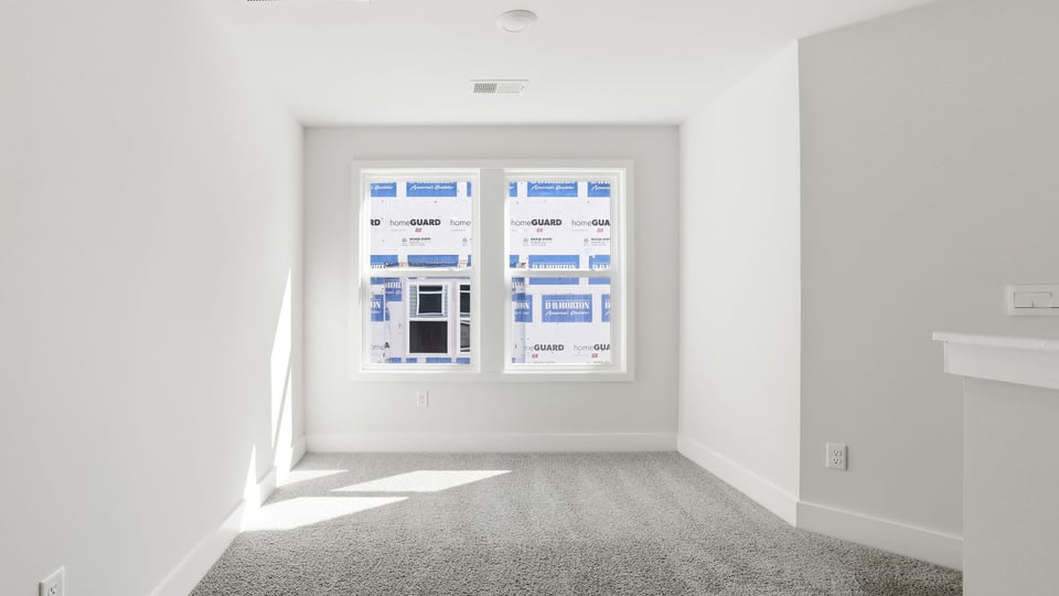 Bedroom with carpet and window.