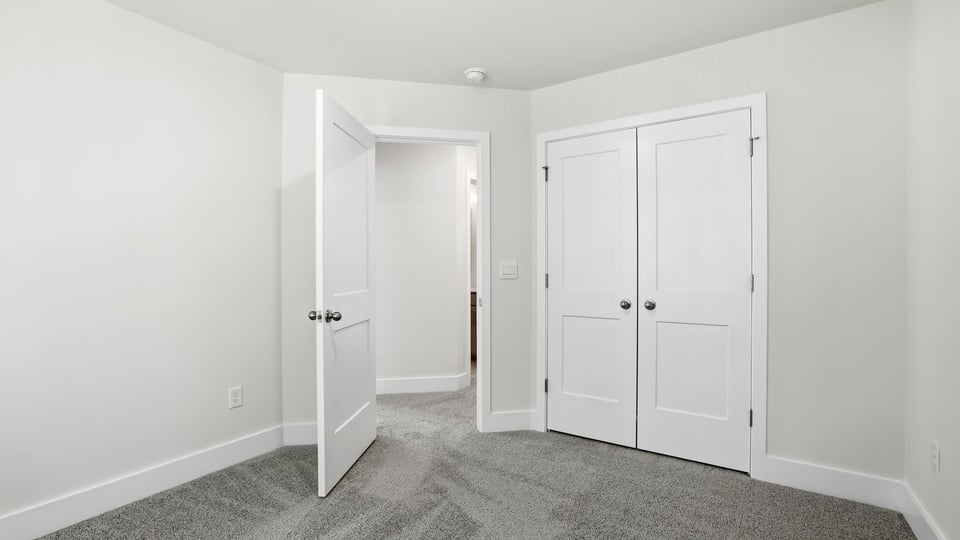 Bedroom with carpet and window.