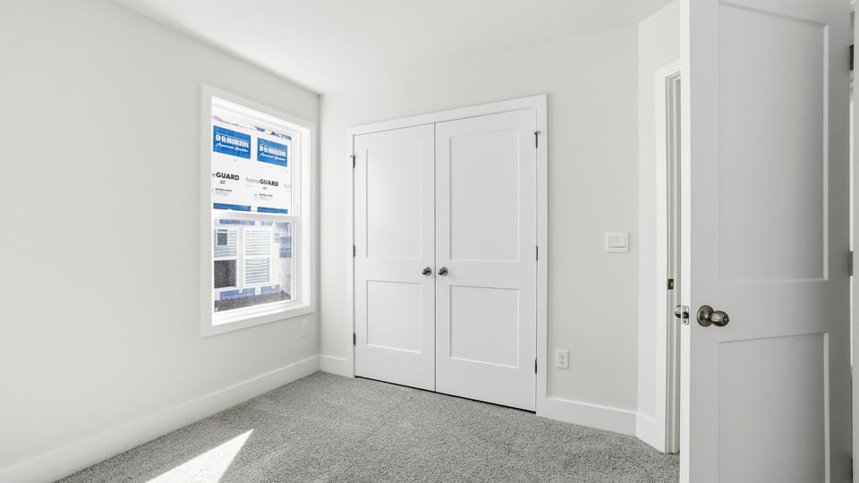 Bedroom with carpet and window.