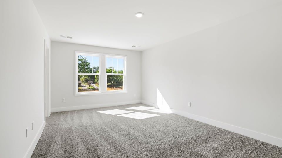 Bedroom with carpet and window.