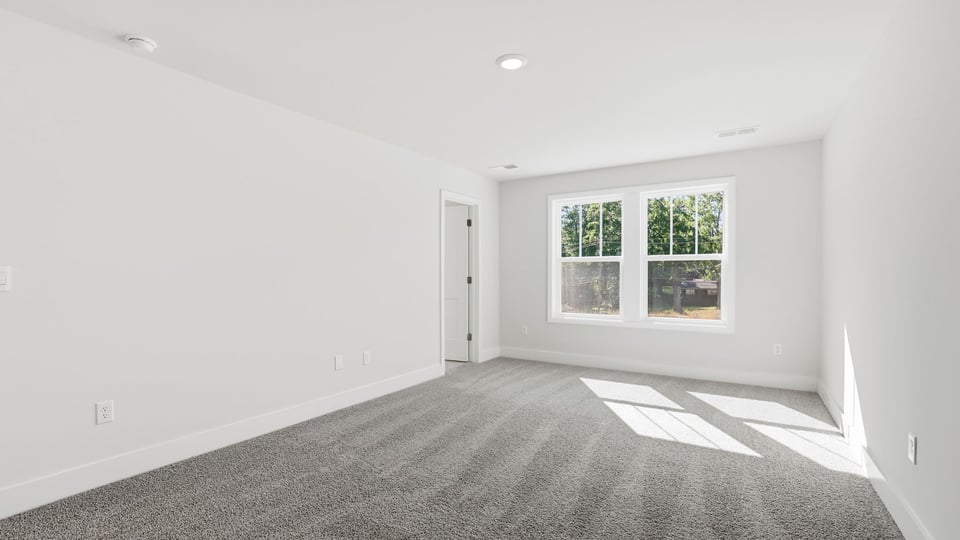 Bedroom with carpet and window.