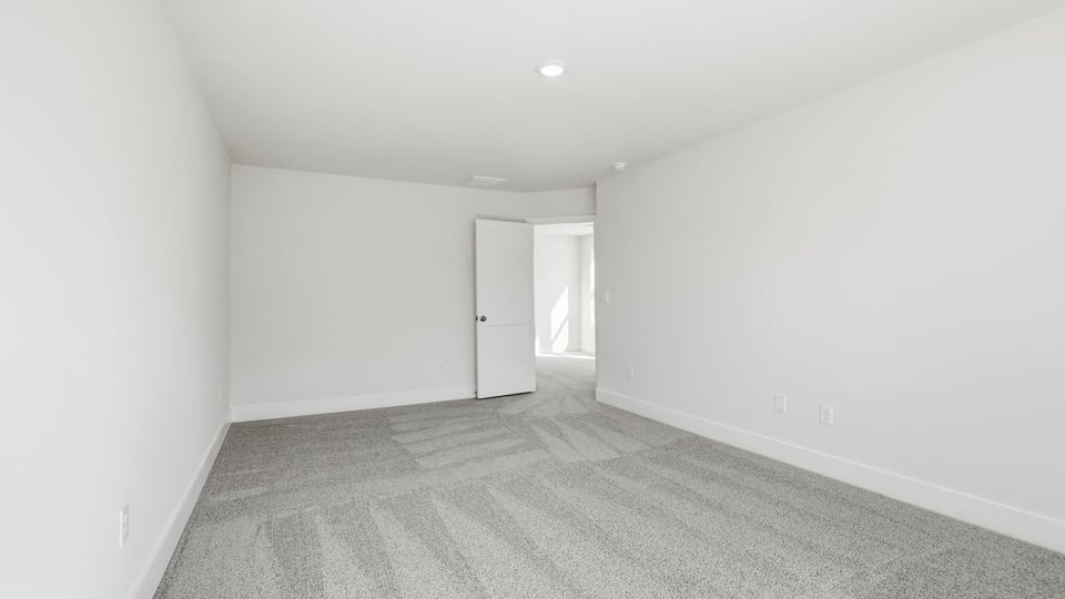 Bedroom with carpet and window.