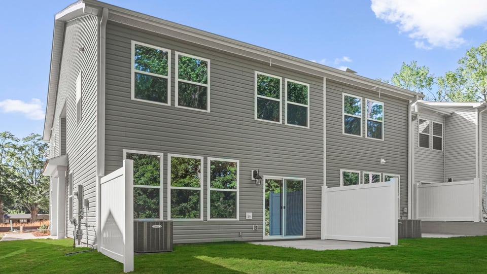 Back exterior of home with large backyard.