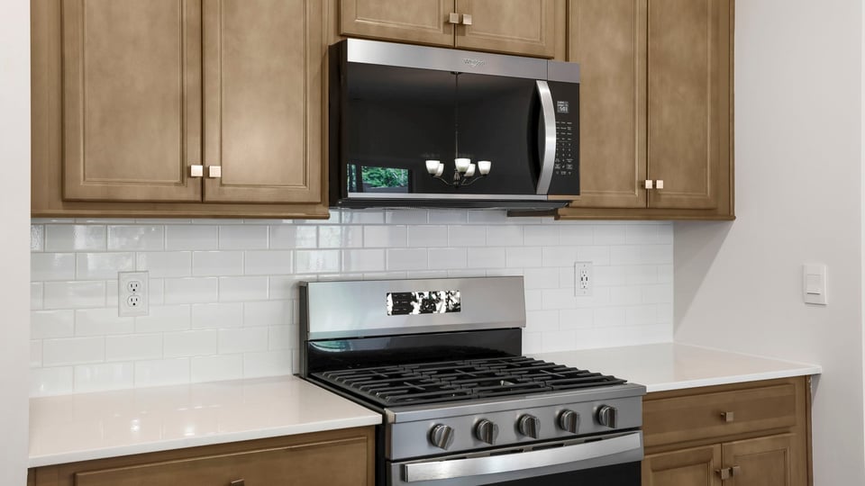 Kitchen and island with stainless steel appliances.