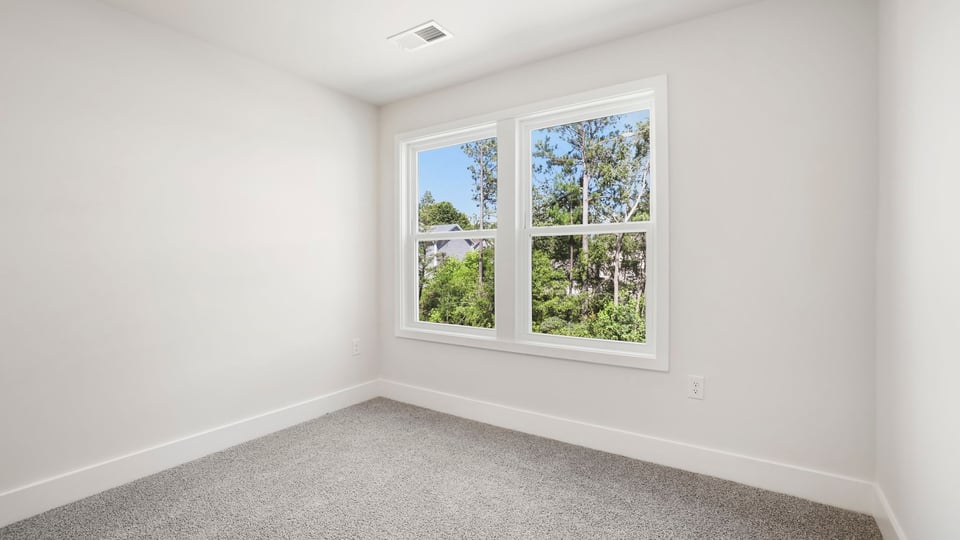 Bedroom with carpet and window.