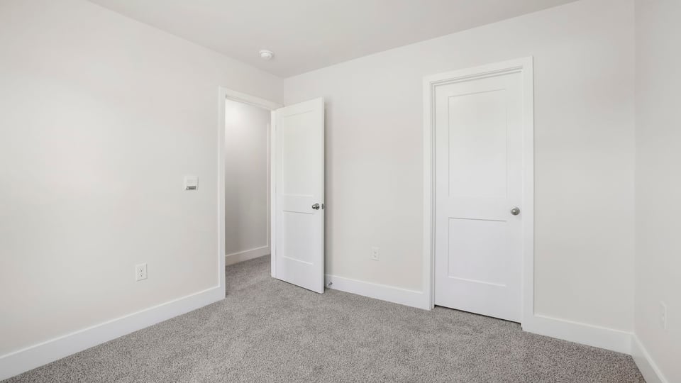 Bedroom with carpet and window.