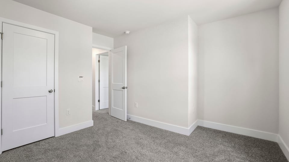 Bedroom with carpet and window.