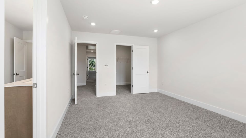 Bedroom with carpet and window.