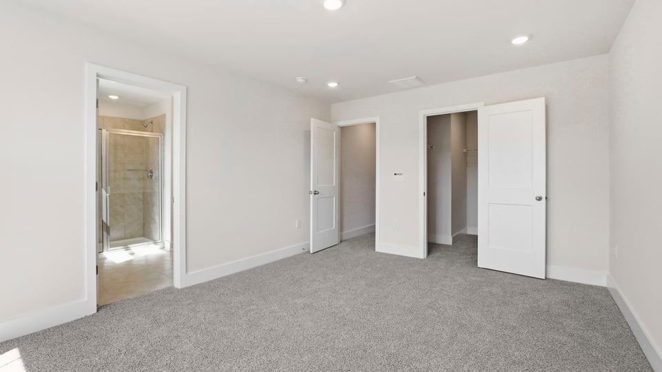 Bedroom with carpet and window.